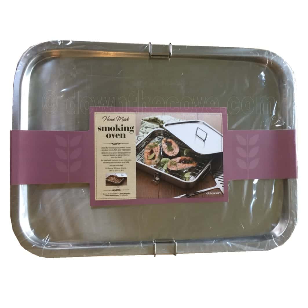 Kitchen Craft stainless steel smoking oven in shrink wrap with a pink product sleeve showing a smoked salmon dish