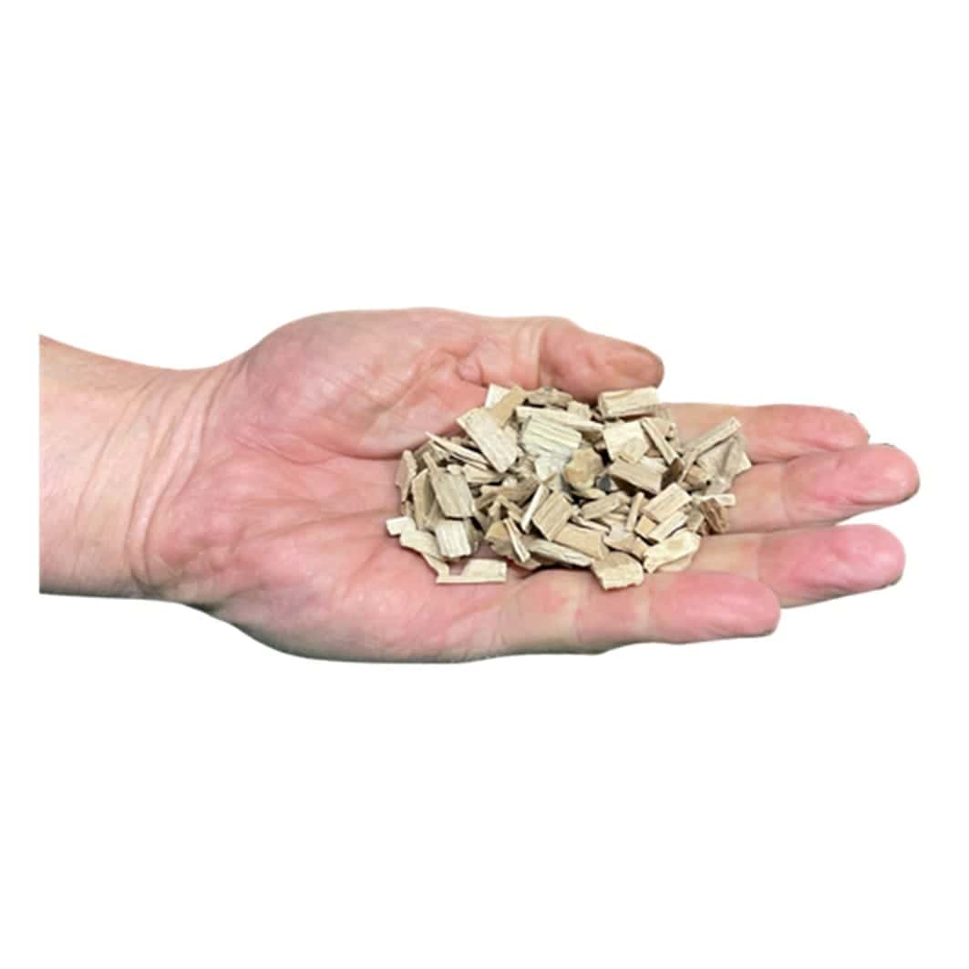 A handful of coarse maple wood chips ready for a BBQ smoke box