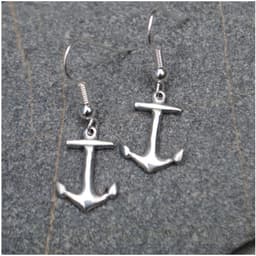 Pair of Cornish Pewter Anchor Earrings on silver ear hooks, resting on slate