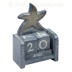Blue-grey washed wooden perpetual calendar topped with a starfish, wooden blocks showing 20 and April