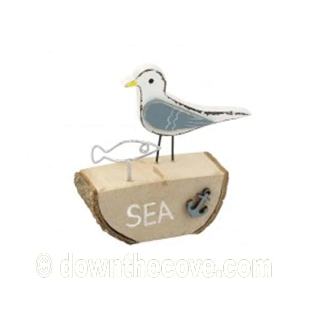 Wooden Seagull With Wire Fish Ornament On Log image 1