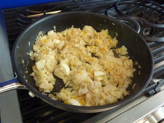 Add cooked rice, 1 chopped hard boiled egg and also 1 beaten raw egg and some salt and pepper. Combine gently