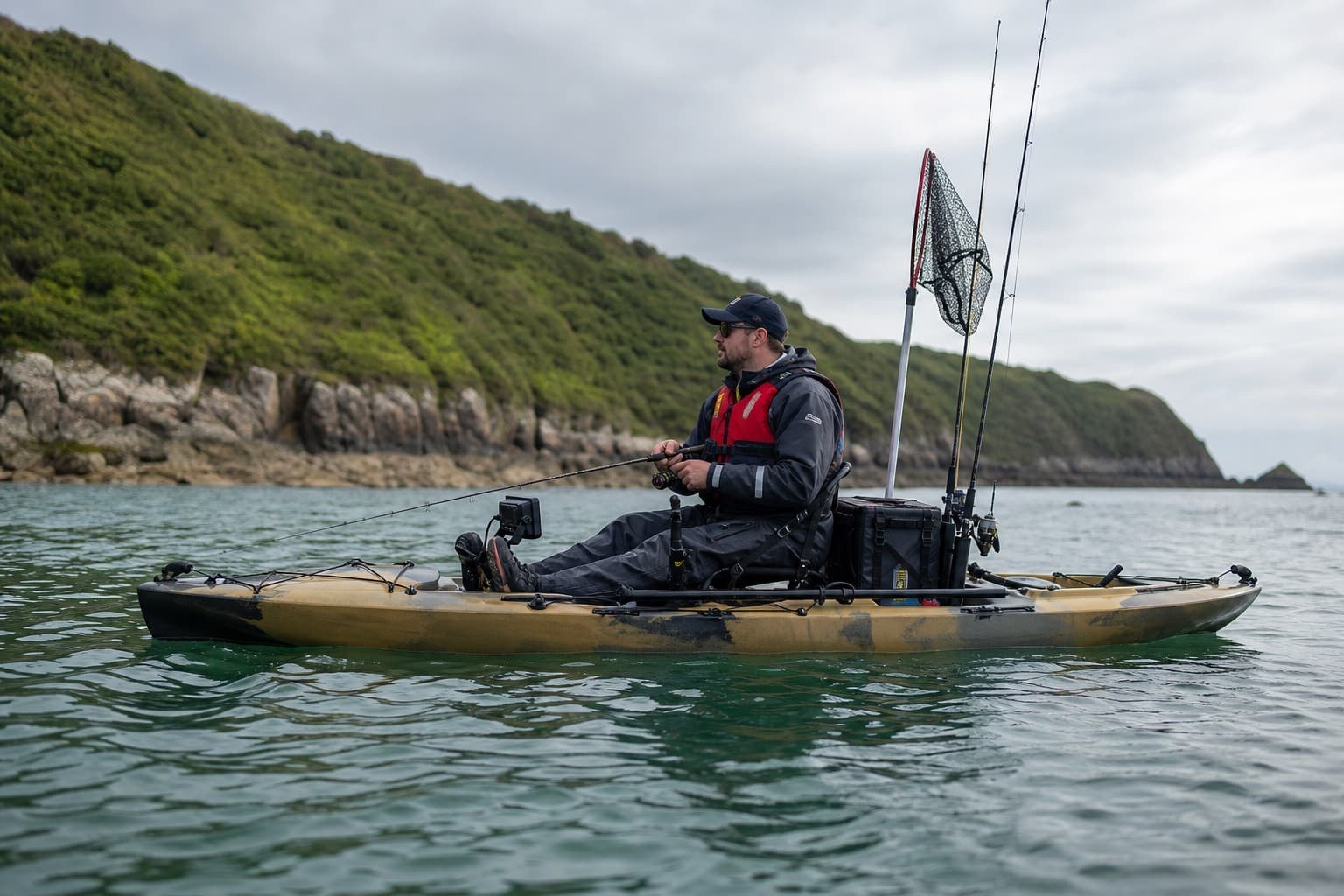 A sea angler wearing a buoyancy aid while fishing from a purpose-built kayak